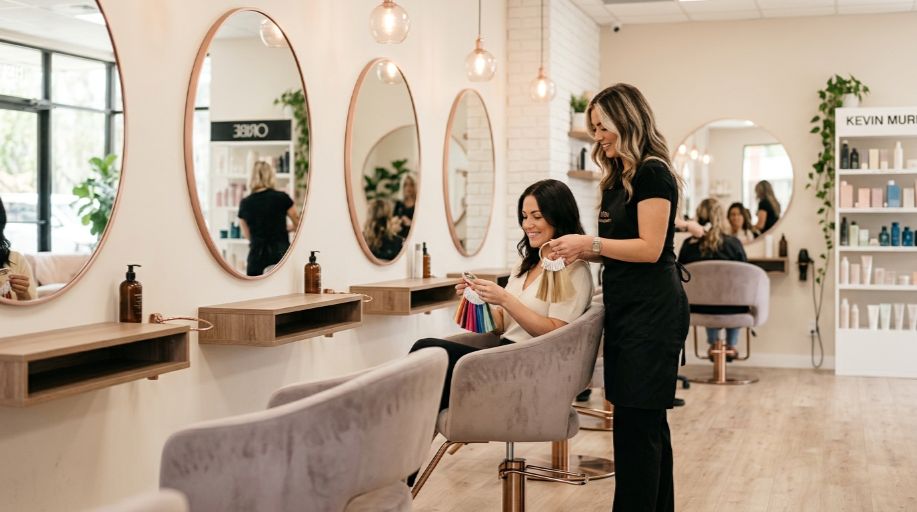 Hair and beauty salon consultation with client reviewing colour swatches